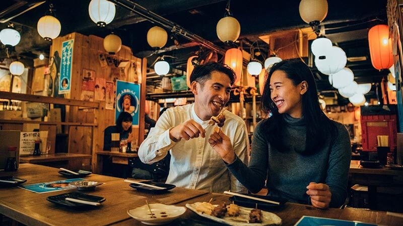 Smiling friends sharing a dinner